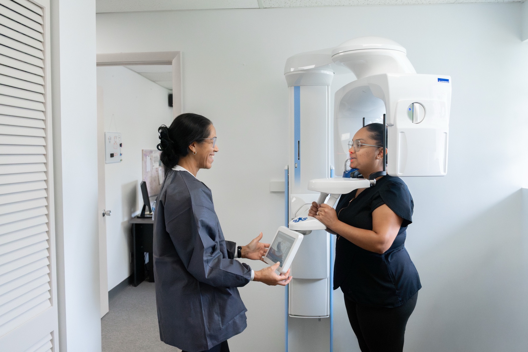 A Gardens team member positioning a patient at the in-office panoramic and CBCT imaging machine