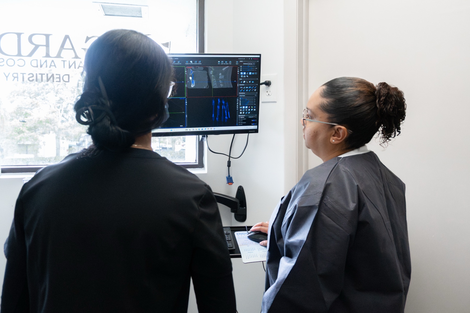 Two Gardens clinicians reviewing a CBCT scan together for oral surgery planning