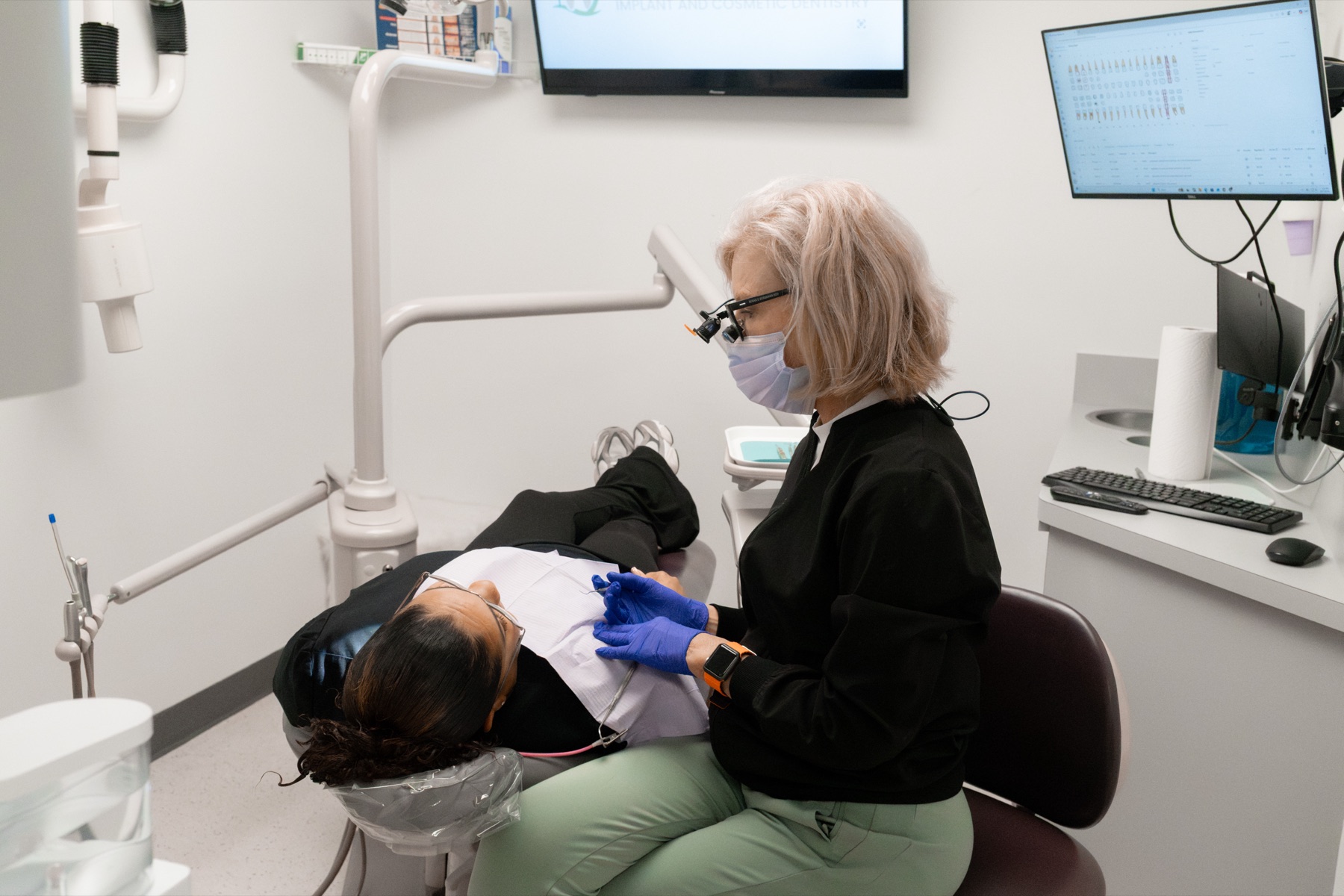 Gardens hygienist treating a patient in a calm operatory in Palm Beach Gardens