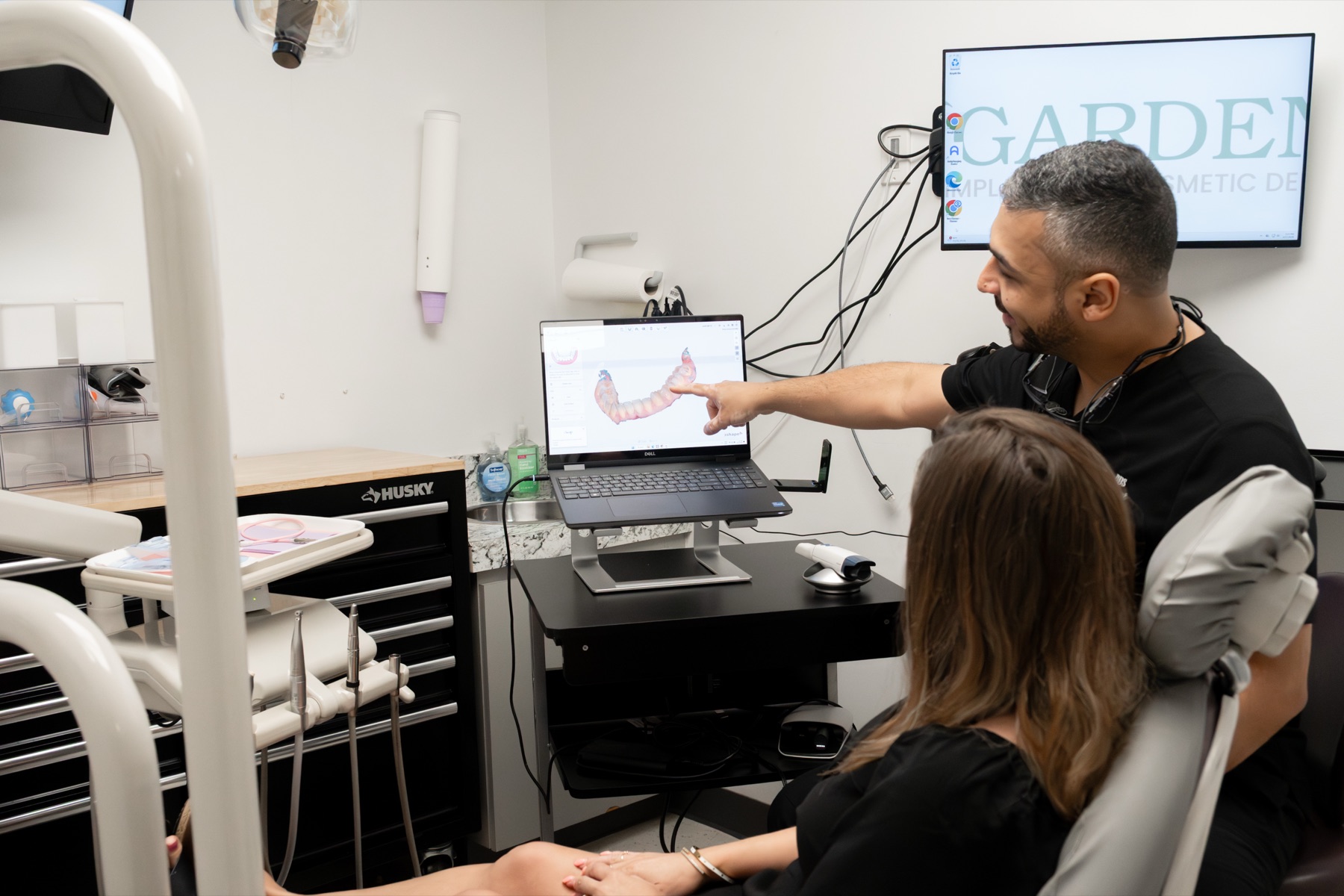 Dr. Almanzar walking a patient through implant treatment options