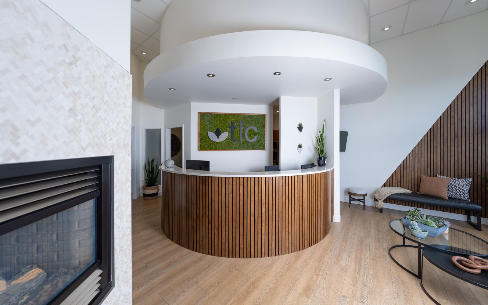 TLC Family Dental Centre curved wood reception desk and waiting area