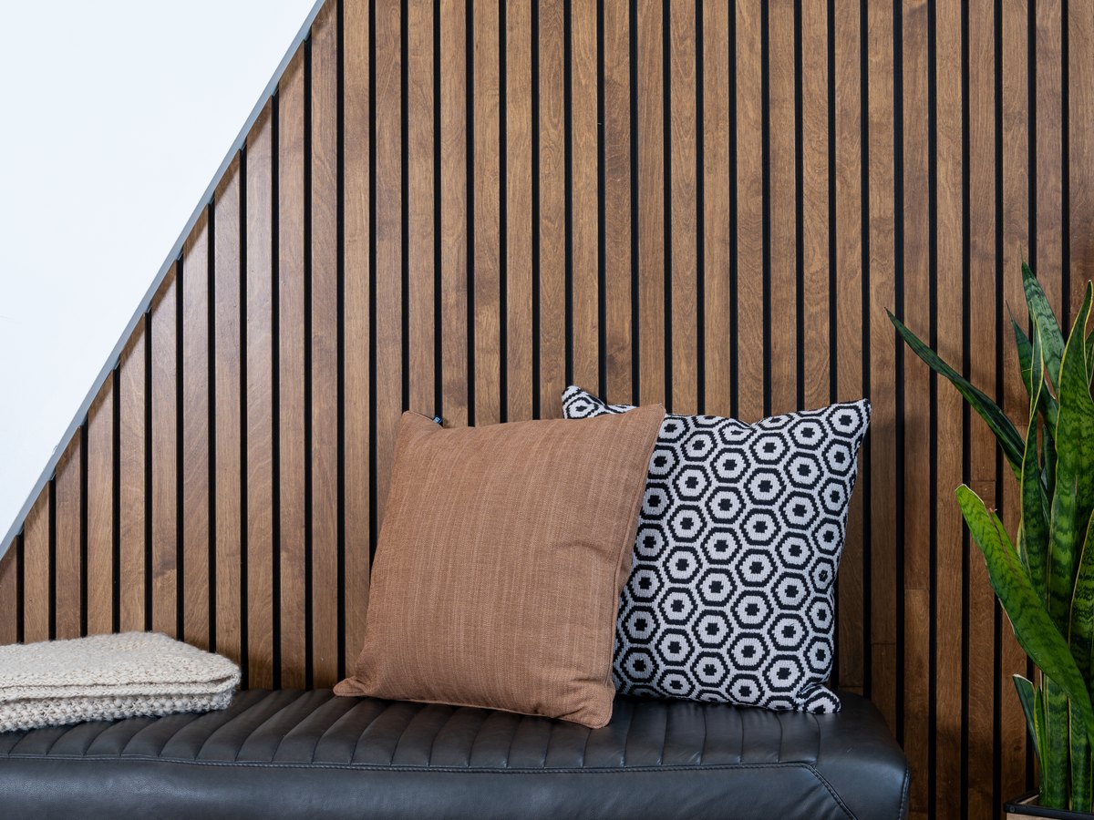 The waiting area at TLC Family Dental Centre in Leduc, with a bench seat against a wood slat wall