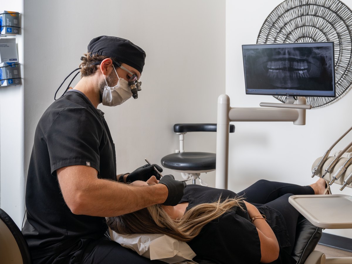 Dr. Kyle Lesko performing a comprehensive dental exam at TLC Family Dental Centre in Leduc
