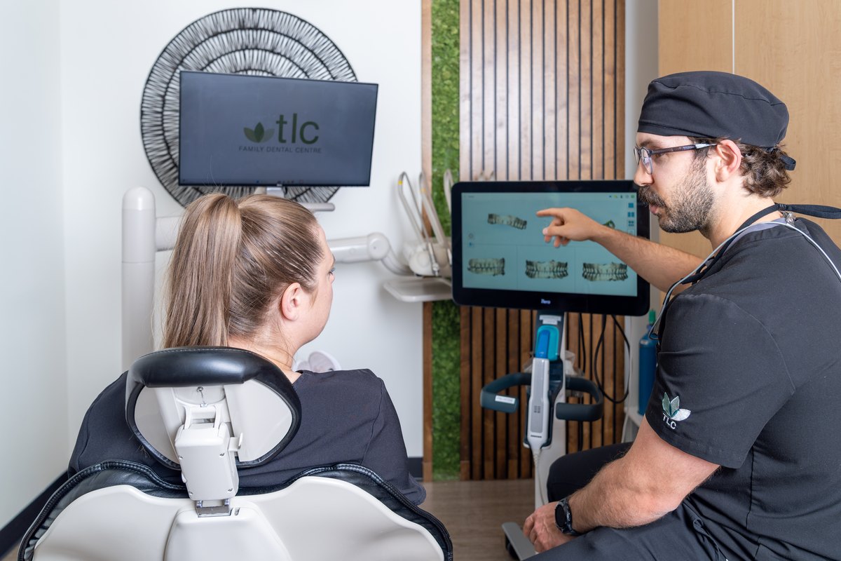 Dr. Kyle Lesko showing a patient their digital scan on the operatory screen at TLC in Leduc
