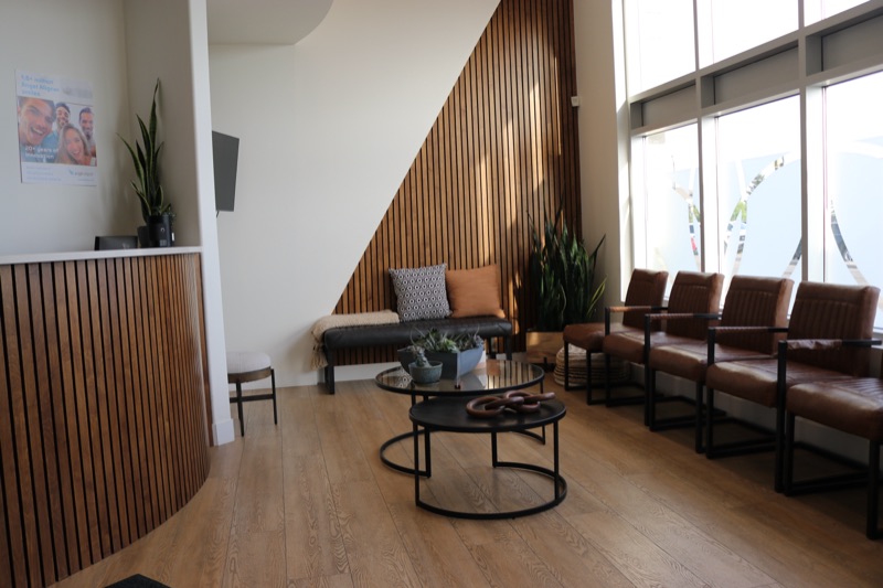 Bright waiting lounge with leather chairs and floor-to-ceiling windows